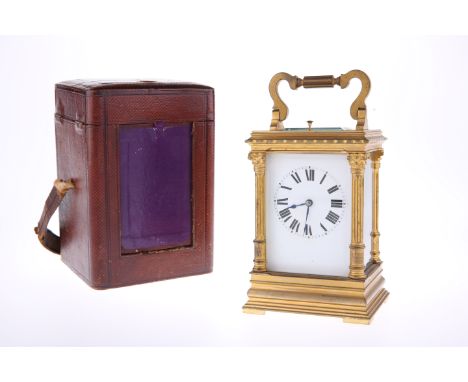 A 19TH CENTURY BRASS CASED CARRIAGE CLOCK WITH PUSH-BUTTON REPEAT, the white enamel dial with Roman numerals, the case with C