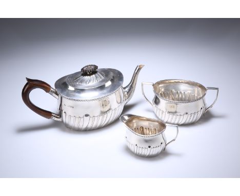 A GEORGE V SILVER THREE-PIECE TEA SERVICE, WILLIAM HUTTON &amp; SONS, LONDON 1903, the part fluted and reeded bodies of oval 