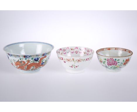 THREE CHINESE PORCELAIN BOWLS, the first painted in a Famille Verte palette with two dragons, 15.5cm diameter; the two smalle