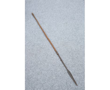 TRIBAL: A SPEAR, with barbed neck and arrow-shaped head. 157.5cm