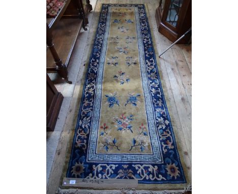 A mid-20th century Chinese runner, having floral sprigs on a light ground surrounded by a repeating pattern on blue ground, 3