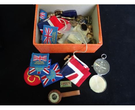 A box containing a quantity of collectable items, including an enamel pin badges relating to the Girl Guides, cloth badges an