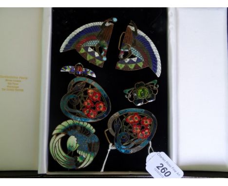 A brass and enamel belt buckle formed as a stylized-scarab beetle, together with a yellow metal (stamped 800) enamel brooch, 