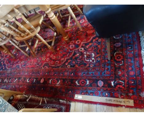A large early 20th century Turkish carpet, having stylized floral pattern throughout, 310cm x 200cm.