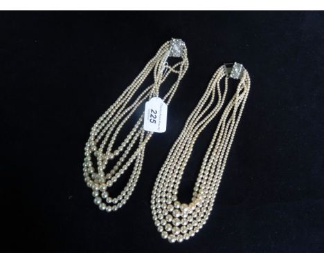 Two early 20th century simulated pearl four strand necklaces, each united by white metal white stone clasp.