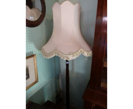 A mahogany standard lamp on plain  circular foot, 152cm.