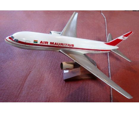 A scale model of a Air Mauritius Boeing 767 aircraft, 48cm long on display stand.