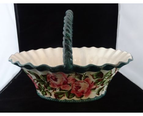 A large early 20th century Wemyss ceramic basket, having rose decoration within green border, impressed mark to base, 41cm x 