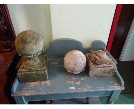 A pair of 19th century stone gate finials of globe form on square stepped base.