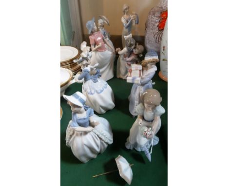 A collection of eight Nao figurines, various sizes, some with original boxes.