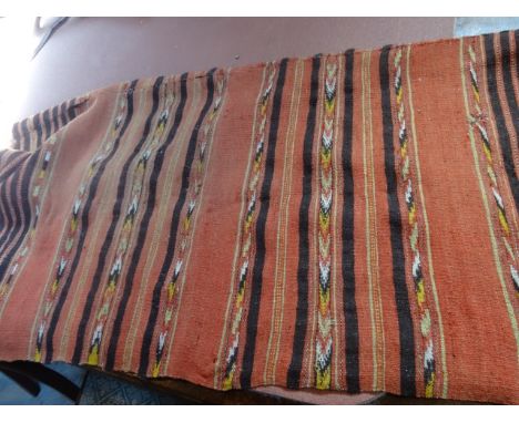 An Afghan carpet with horizontal repeating stripes on a salmon pink ground, 238cm x 114cm.