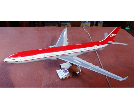 A scale model of a A330-300 aircraft, having German LTU livery, 62cm long on display stand.