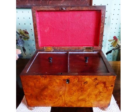 A mid-19th century bur walnut tea caddy of rectangular form, having twin lead lined covered internal compartments on four bun
