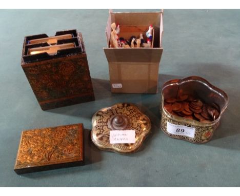 A decorative tin containing a quantity of 20th century Indian half Anna coins, together with an Indian papier mache box conta