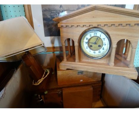 A 1930's oak and bakelite table lamp in the Art Deco-style, together with a contemporary oak large mantle clock, having Frenc