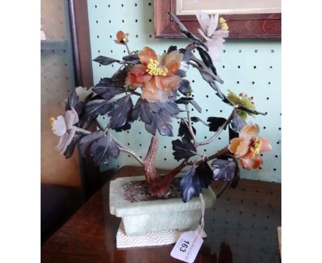 A pair of jade miniature plant troughs containing artificial flower displays. Condition Report: Some small chips but no crack