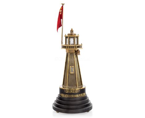 A LIGHTHOUSE LAMP, CIRCA 1920constructed in hexagonal brass body to lighting chamber with flag, mounted on stepped ebonised b