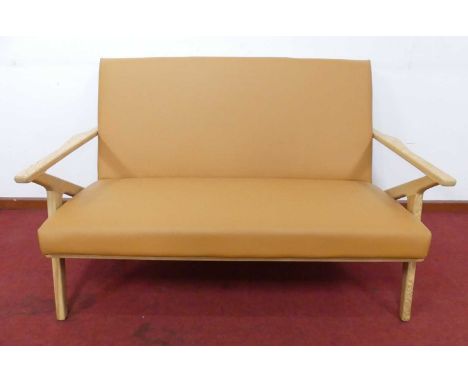 A contemporary blond ash framed and soft tan vinyl upholstered two-seater sofa, after the 'Z' design by Poul Jensen, the slig