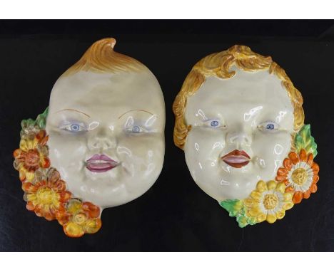 A pair of 1930s Clarice Cliff pottery 'Jack &amp; Jill' wall masks, each typically relief moulded with bright colour painted 