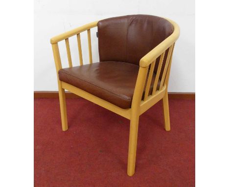 A Norwegian beech framed tub armchair by Skalma, with cognac brown leather upholstered pad back and fixed seat, slatback deta