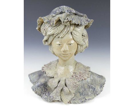 Catido (French, b.1945) - a studio pottery head and shoulders bust of a woman, modelled wearing a bonnet and a fringed blouse