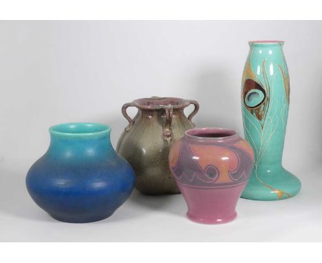 An Art Nouveau Sarreguimines pottery vase, decorated with peacock feathers, h.28cm, together with a Royal Lancastrian blue gl