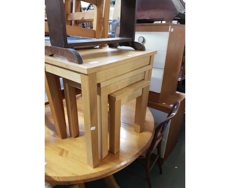 A NEST OF MODERN LIGHT WOOD TABLES