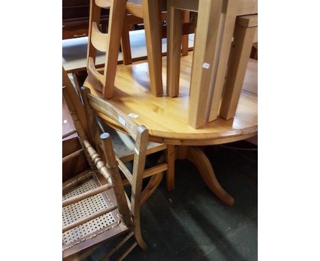 A ROUND PINE TABLE AND 4 LADDER BACK CHAIRS