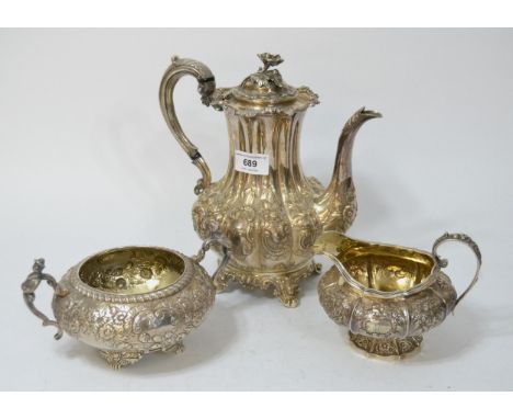 Victorian silver floral embossed coffee pot, together with a similar cream jug and sugar basin, 52.5oz t 