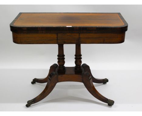 George III rosewood crossbanded card table with baize lined interior, turned column support with swept legs having cast brass