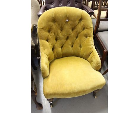 19th Century button upholstered low seat nursing chair, on turned tapering supports with brass and ceramic casters 