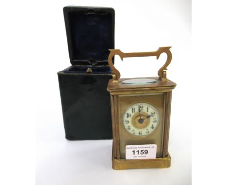 Brass cased carriage clock with circular dial having Arabic numerals and travel case (at fault) 