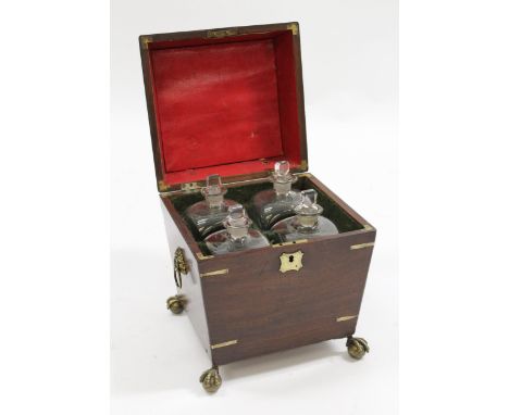 George III mahogany brass mounted decanter box of waisted form, the hinged cover enclosing original fitted interior with four