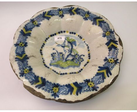 18th Century Delftware dish decorated with a central winged female figure in shades of blue and yellow, 35cm diameter (extens