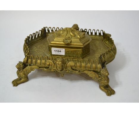 Ornate late 19th / early 20th Century French brass inkwell, the hinged cover enclosing two red glass lined wells, the galleri