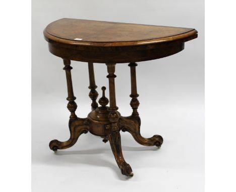 Victorian demi lune walnut inlaid card table on turned column supports having cabriole carved legs with brass and ceramic cas