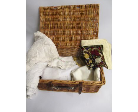 Wicker hamper containing a collection of various table linen etc. 