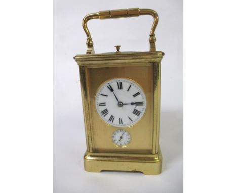 20th Century gilt brass carriage alarm clock having enamel dial with Roman numerals, date aperture and alarm dial striking on