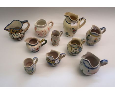 Group of ten various small Quimper pottery jugs 