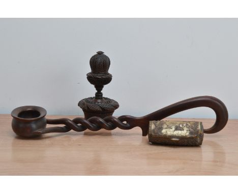 A black forest hand carved wooden nutmeg grater and jar,  14.5cm high, together with a hand carved wooden ladle 39.5cm in len