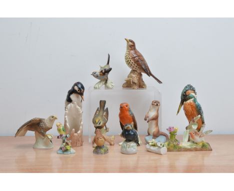 A collection of ceramic bird figurines, comprising examples from Goebel, the tallest 18cm high, a Beswick bird 14cm high and 