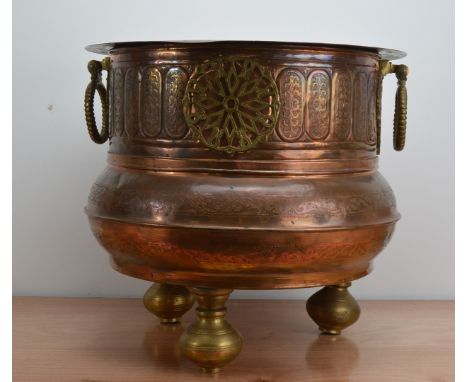 A large early to mid 20th century Indian copper and brass twin handled planter, brass circular drop handles, globular body, r