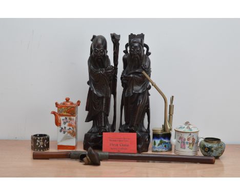 A collection of Chinese works of art, comprising two carved hardwood figures, both 34cm high, a wooden opium pipe and an enam