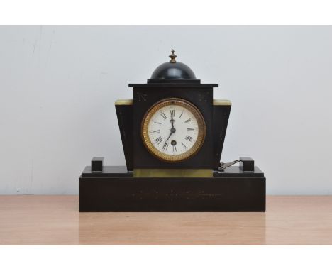 An Art Deco style mantle clock, domed top mounted with a brass finial, white enamel dial with Roman numerals, winder present,