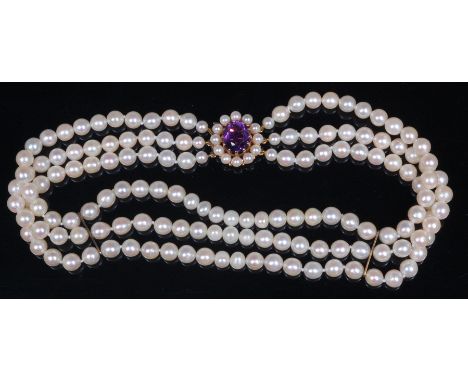 A cultured pearl triple string choker, having 9ct gold, amethyst and seed pearl set clasp, average pearl dia. approx 6mm, len