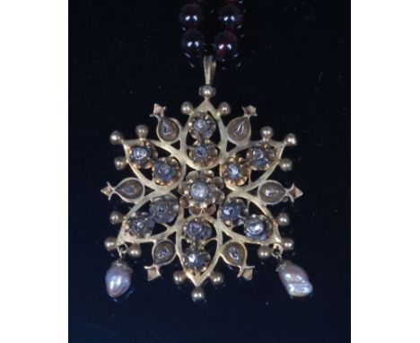 A 19th century yellow metal diamond and pearl snowflake pendant brooch, set with an arrangement of rough cut diamonds, suppor
