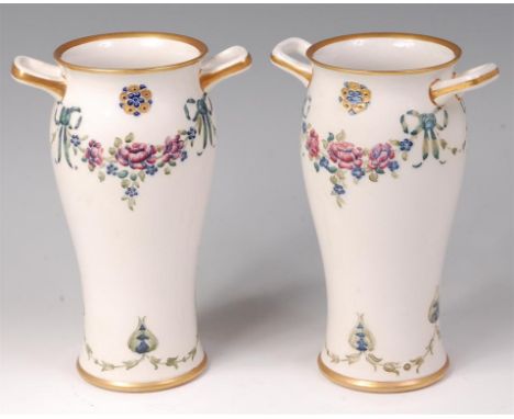 A pair of Moorcroft MacIntyre glazed pottery twin handled vases, in the 18th century pattern, each with finely stylised tube-