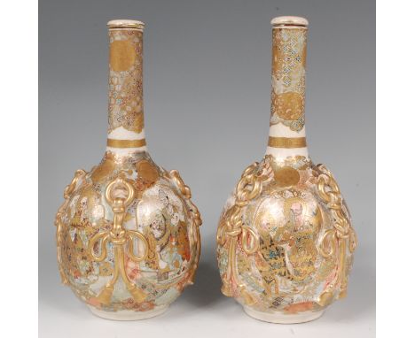A pair of Japanese Meiji period satsuma bottle vases and covers, each decorated    with four reserves of ceremonial figure sc