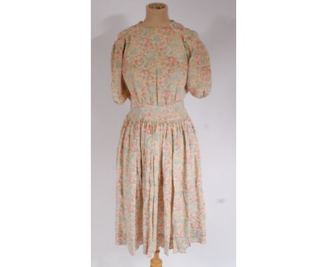 A 1930s printed silk tea dress, with folk styling to front and full gathered skirt Condition Report / Extra Information Light
