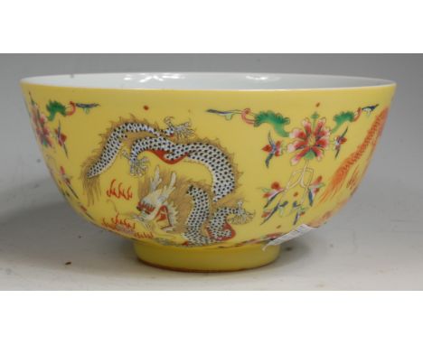 A Chinese porcelain  yellow ground bowl, the exterior enamel decorated with four dragons chasing the golden pearl, the interi